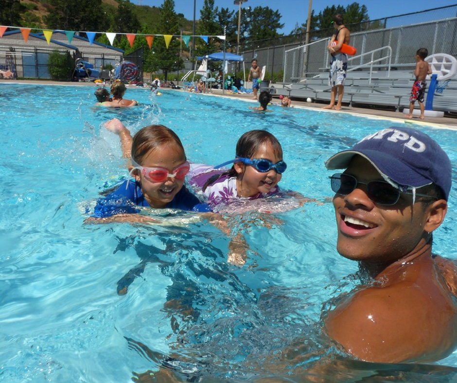 Campers learning to swim from their swim counselor