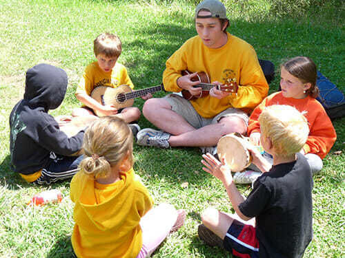 Young Campers Play Instruments as a Group at the Reservoir