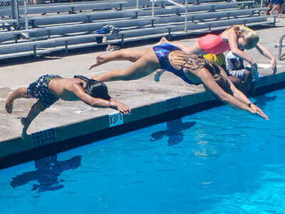 Teen Campers Dive into Deep Pool During Swimming