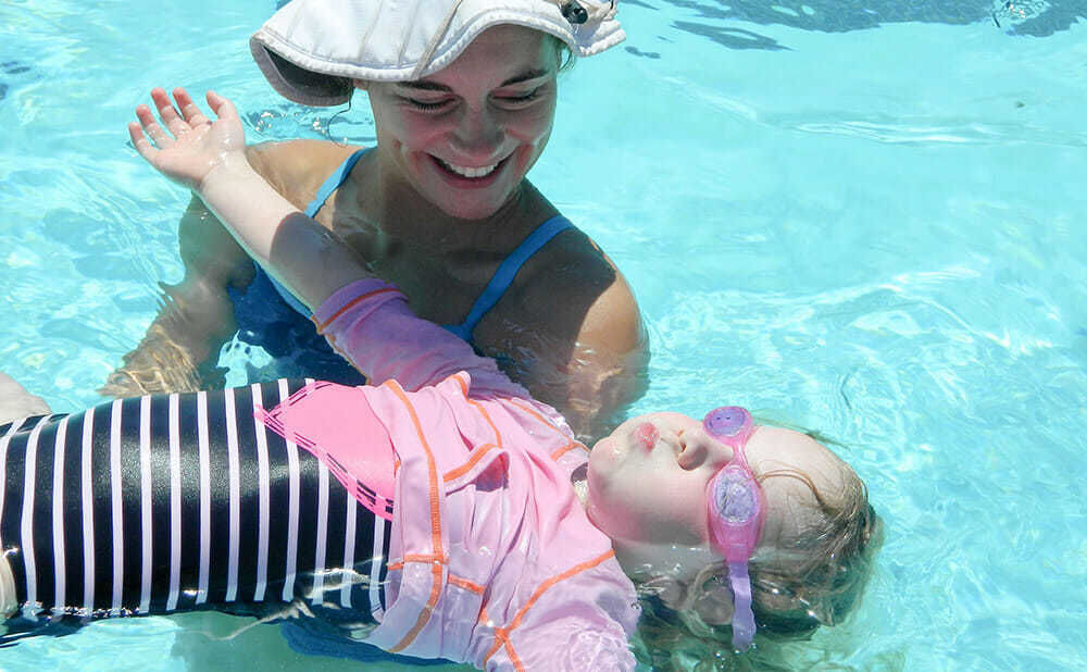 Young Camper Learns to Float in Swimming