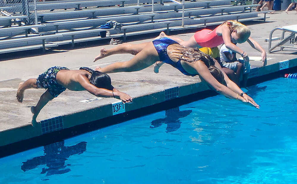 Teen Campers Dive into Deep Pool During Swimming