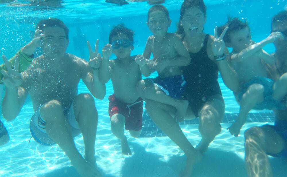 Campers Pose Underwater with Counselors during Free Swim