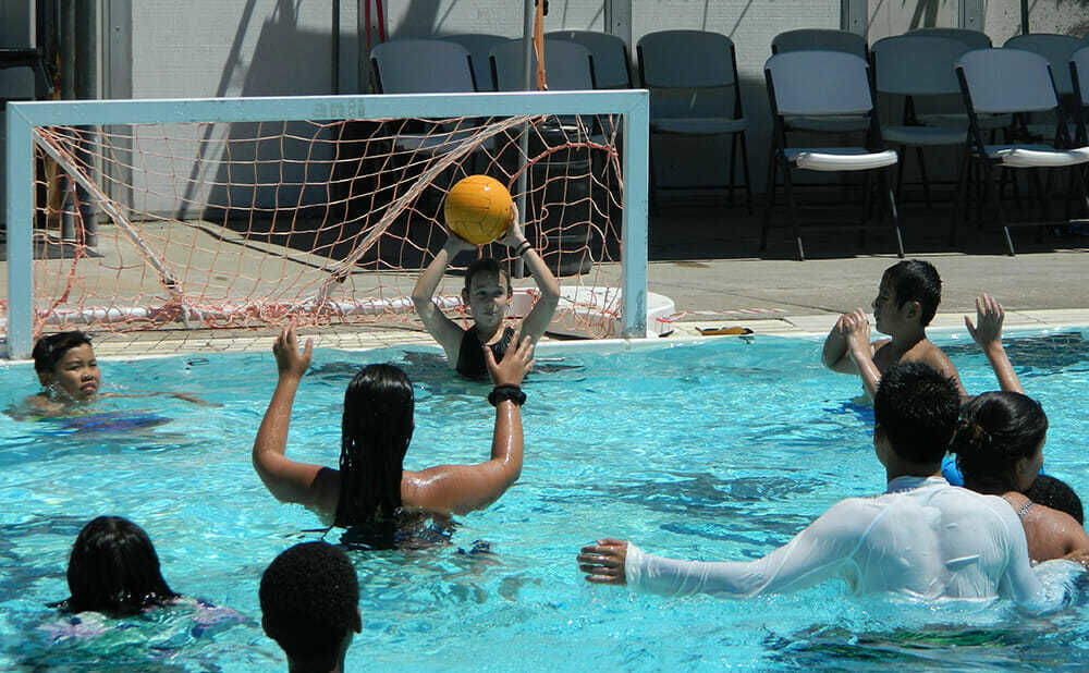 Teen Campers Play Water Polo at Swimming