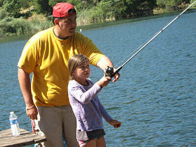 Girl Camper Learns to Cast in Fishing