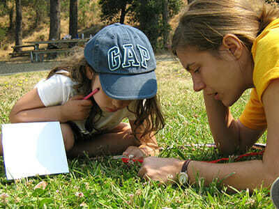 Young Camper Learns About Bugs in Environment