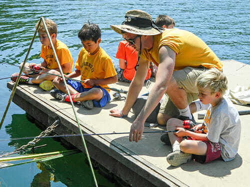 Young Boy Campers Learn to Fish