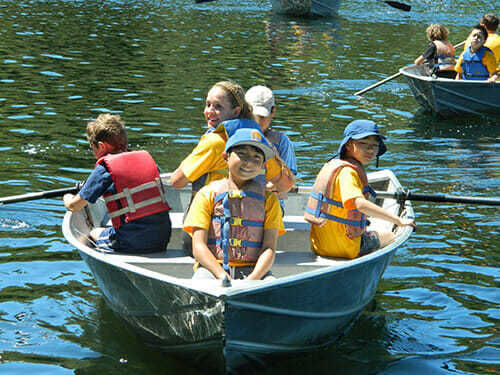 Young Campers Navigate their Rowboat in the Reservoir