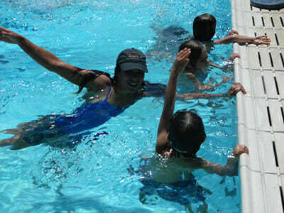 Young Campers Practice Freestyle in the Pool