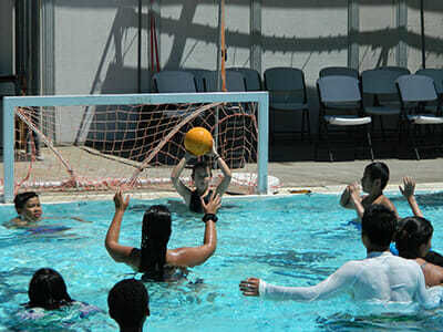 Teen Campers Play Water Polo at Swimming