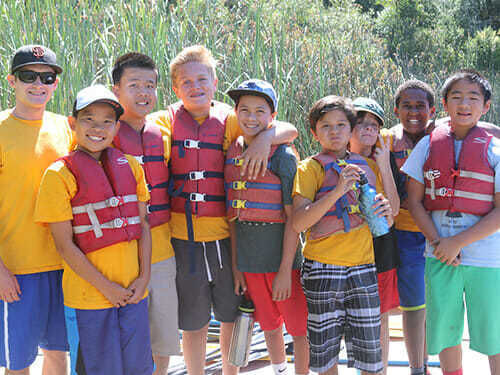 Preteen Boy Campers Stand Wearing PFDs