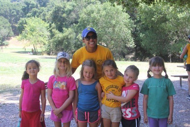 Camper group and Counselor smiling together at Lafayette Reservoir 