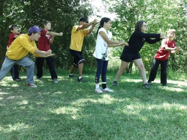 Teen boys perfroming camp skit at lafayette reservoir, cooling counselor off. 