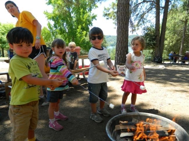 4 year olds campers learn how to build a campfire, and all about fire safety by cooking their own s'mores with their counselors.