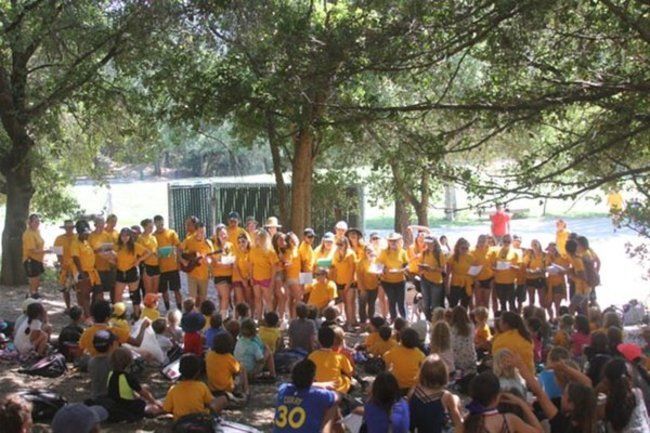 Counselors sing camp song to campers at closign circle at lafayette reservoir 