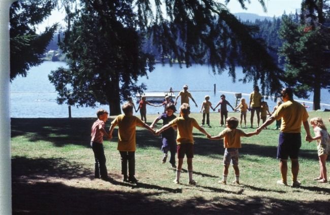 Campers standing in a circle holding hands.